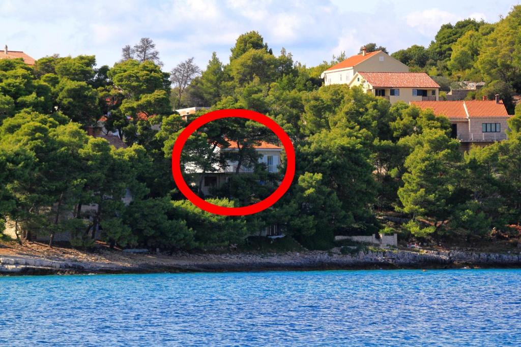 a house on the shore of a body of water at Apartments and rooms by the sea Lumbarda, Korcula - 9272 in Lumbarda