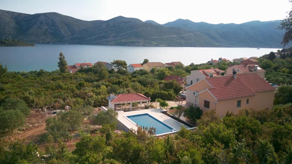 an aerial view of a house with a swimming pool at Seaside apartments with a swimming pool Kneza, Korcula - 9269 in Račišće
