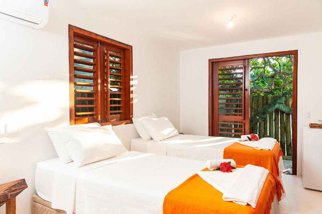 カライーバにあるMirante Caraivaのベッド2台と窓のある寝室