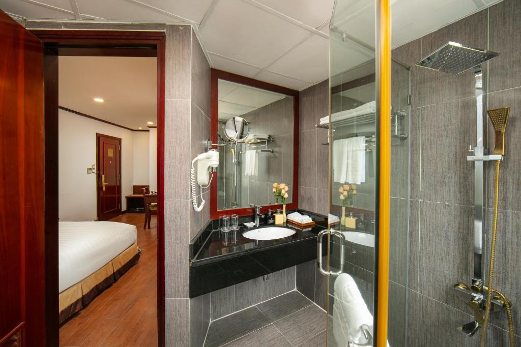 a bathroom with a sink and a shower at May De Ville Trendy Hotel & Spa in Hanoi
