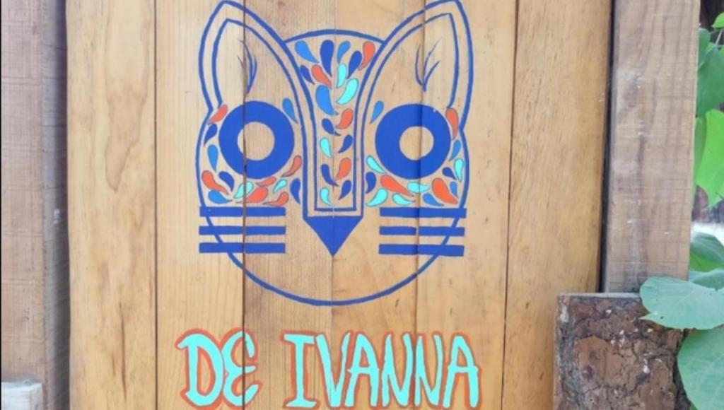 a painting on a wooden wall with the words be naama at Ivanna hostel mazunte in Mazunte