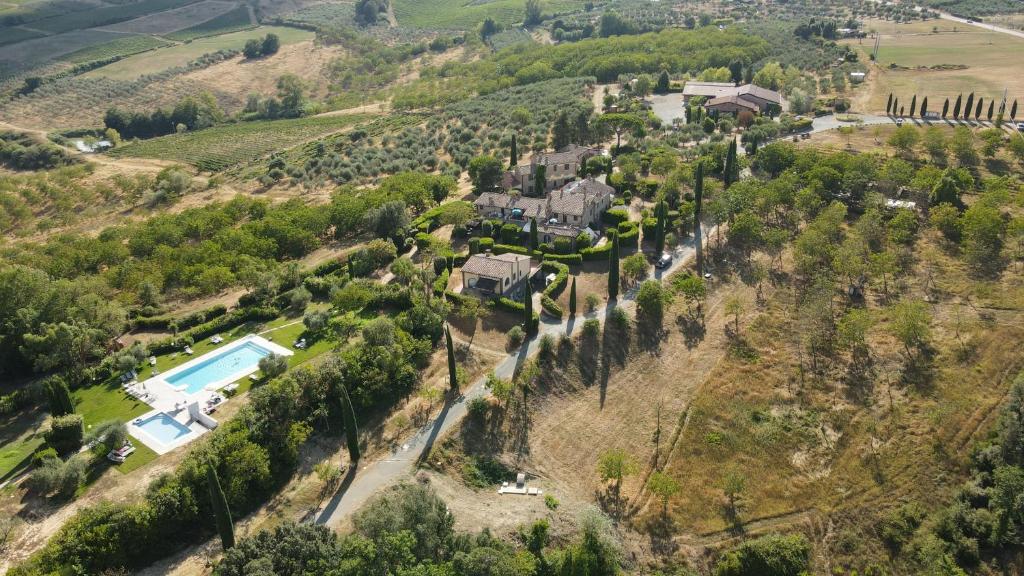 an aerial view of a house with a pool on a hill at Agriturismo Santa Cristina in Gambassi Terme