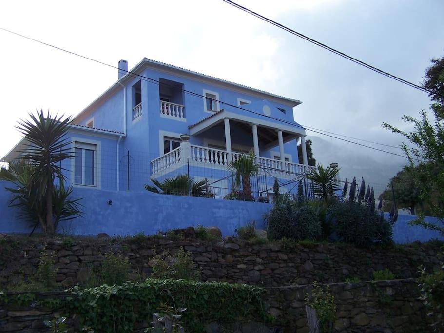 a blue house on a hill with at Casa Azzura in Bastia