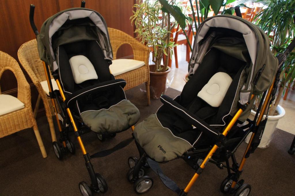 two strollers sitting next to a table and chairs at Hotel Abest Naha Kokusaidori in Naha