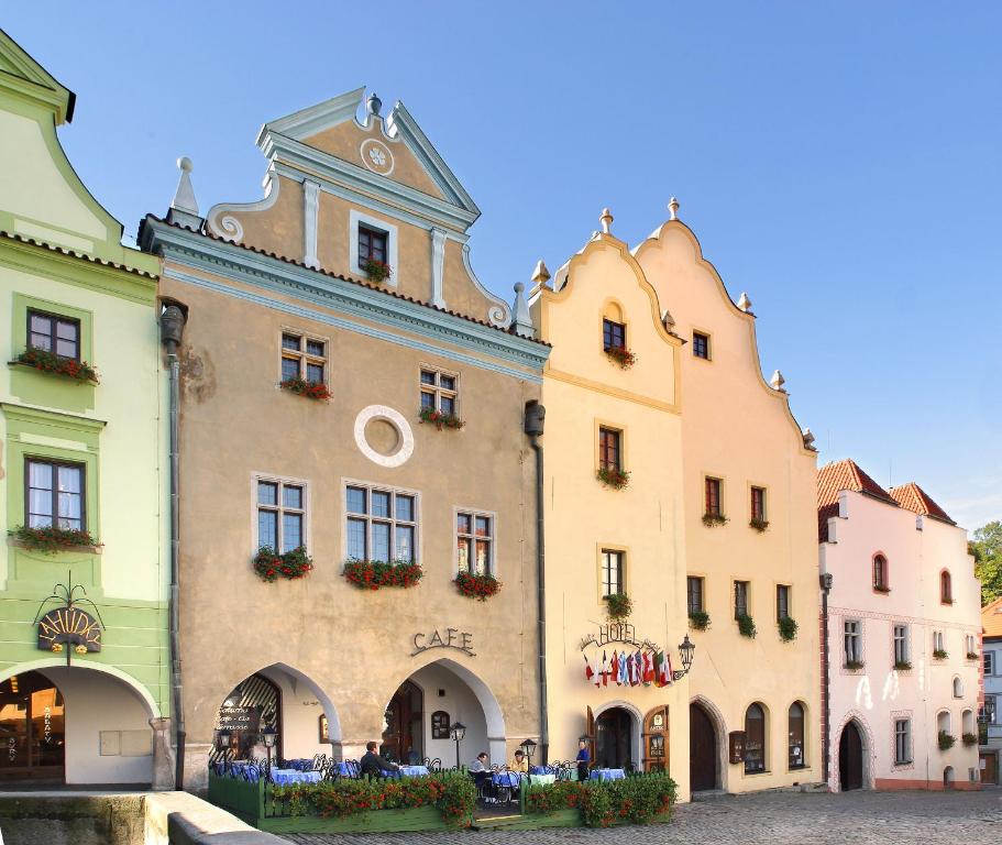 a large building with a clock on the front of it at Hotel Zlaty Andel in Český Krumlov