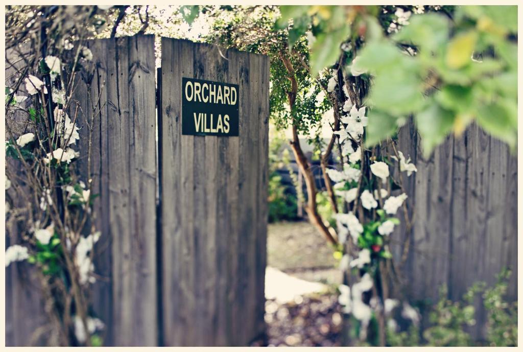 a sign on the side of a wooden fence at Lake Orchard Villas in Daylesford