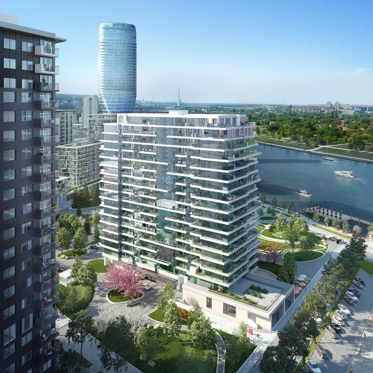 an aerial view of a large building next to a river at BW TERRACE top floor apartments with river view & self check-in in Belgrade