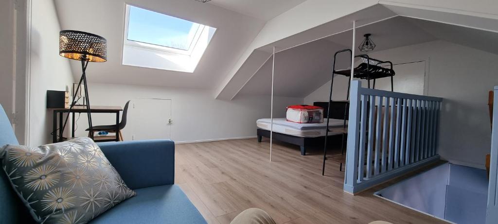 a living room with a blue couch and a table at L'AUBERGADE in Vittel