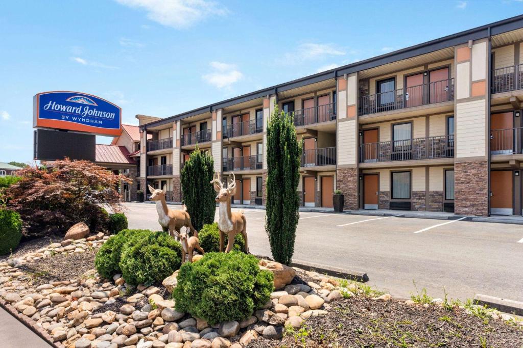 a hotel with two deer statues in front of a building at Howard Johnson by Wyndham Pigeon Forge in Pigeon Forge