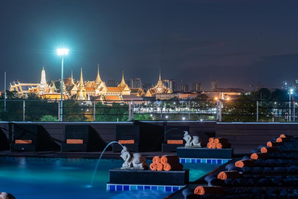 a view of a city skyline at night at Dang Derm In The Park Khaosan in Bangkok