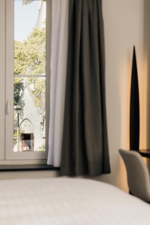 Postel nebo postele na pokoji v ubytování Hotel Au lit des ours
