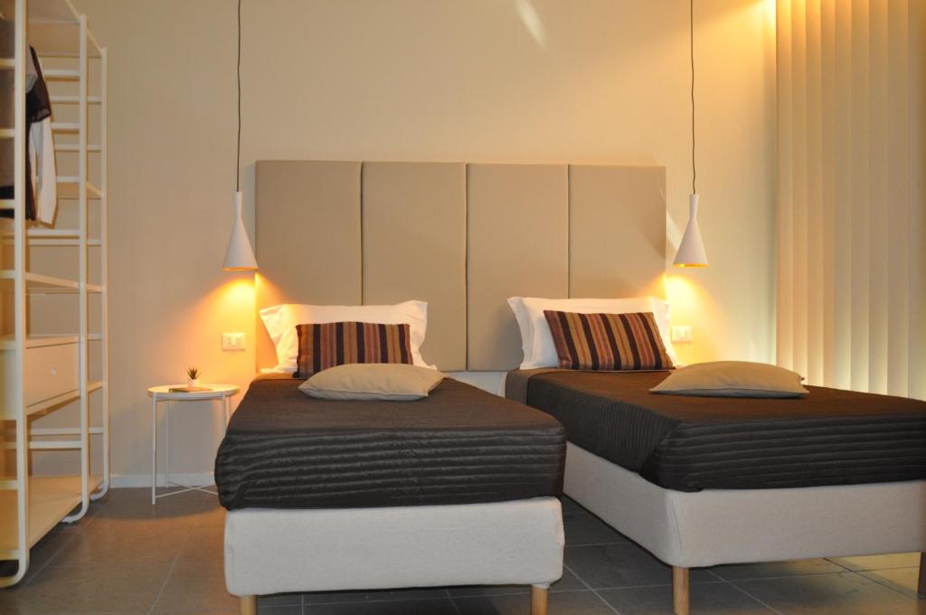 Posteľ alebo postele v izbe v ubytovaní Garda Bloom Holiday Apartments