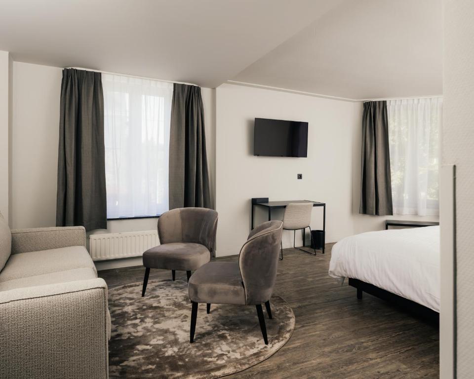 TV a/nebo společenská místnost v ubytování Hotel Au lit des ours