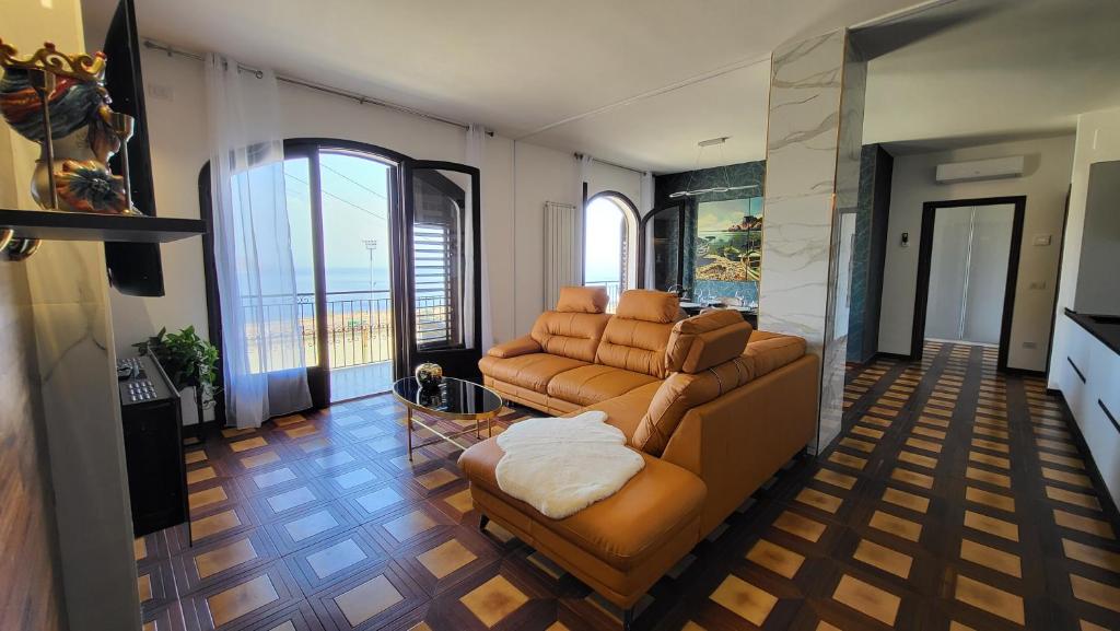 a living room with a couch and a chair at I Due Grifoni Luxury Apartment & Spa in Taormina