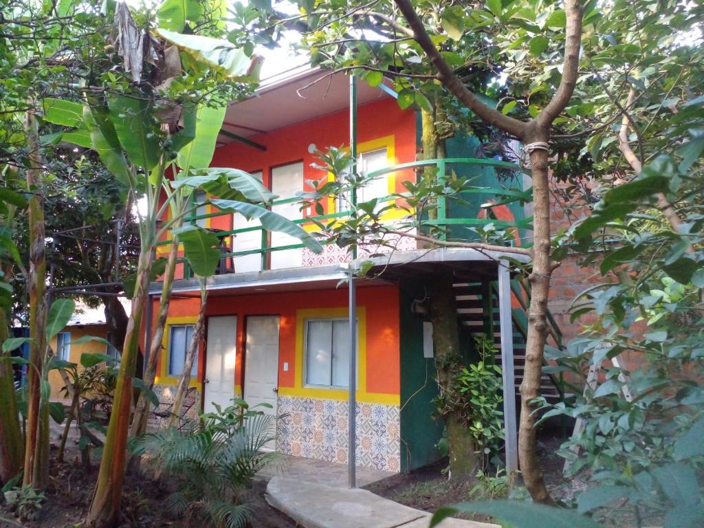 a colorful house in the middle of a forest at montecarlos hotel in Ibagué