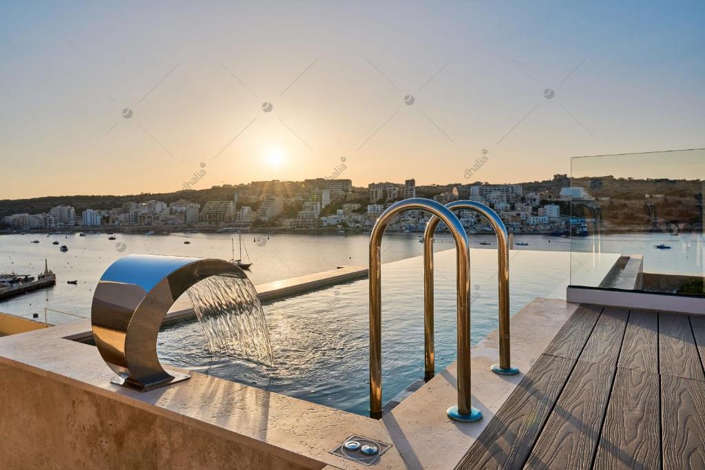 a pool with a water fountain on top of a building at Luxury House with Pool-Hosted by Sweetstay in St Paul's Bay