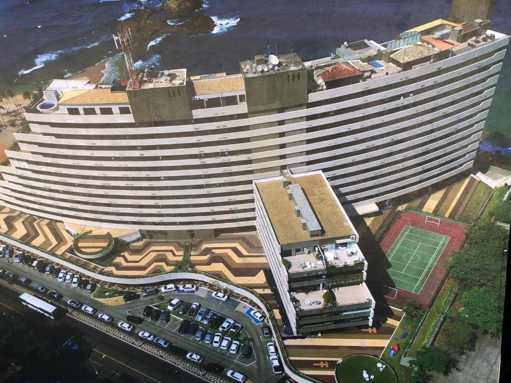 an overhead view of a large building next to the ocean at Apart Hotel em Ondina Salvador in Salvador