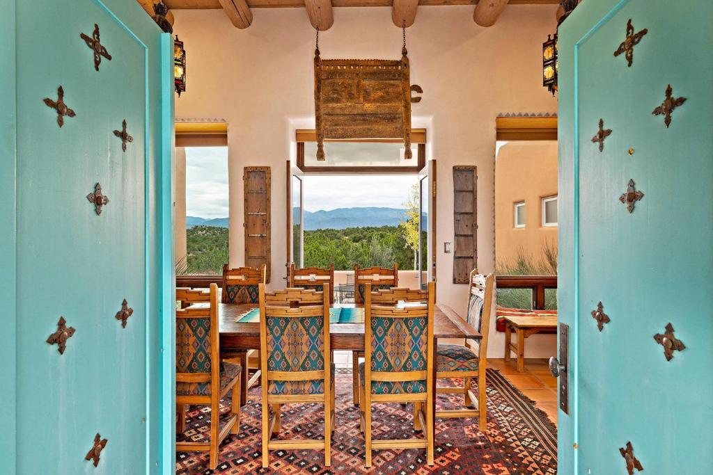 a room with a dining room with a table and chairs at 103 B Estrellas de Tano in Santa Fe