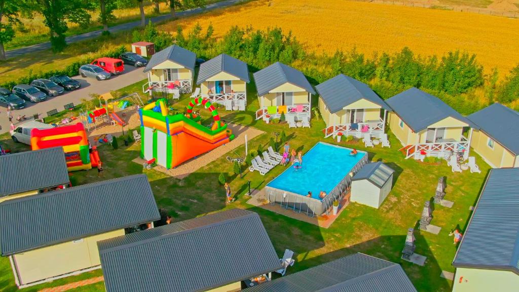 an aerial view of a house with a playground and a pool at Holiday Camp Sarbinowo in Sarbinowo