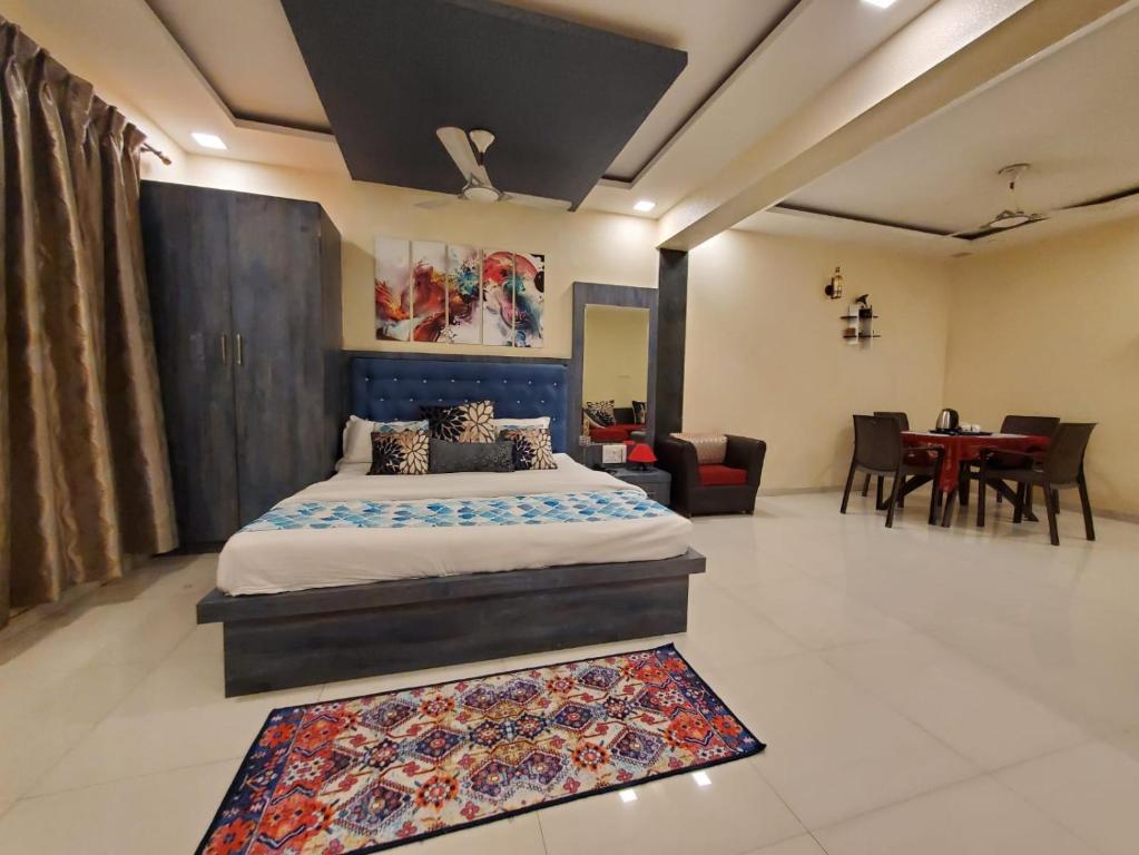 a bedroom with a bed and a dining room at Hotel Mari Aai Residency in Navi Mumbai