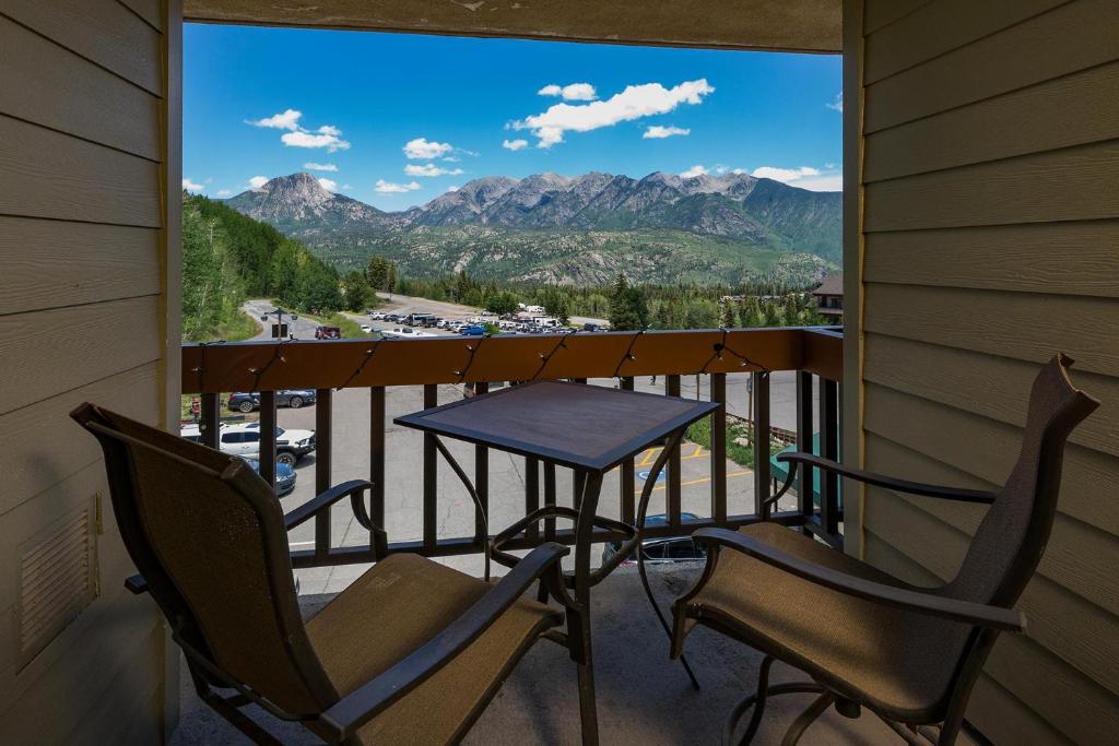 a balcony with a table and chairs and mountains at Kendall 444 in Durango Mountain Resort