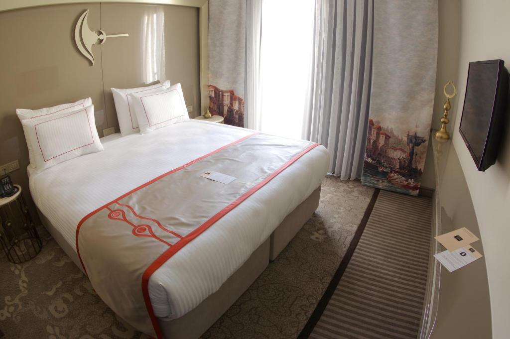 Postel nebo postele na pokoji v ubytování Peyk Hotel Oldcity