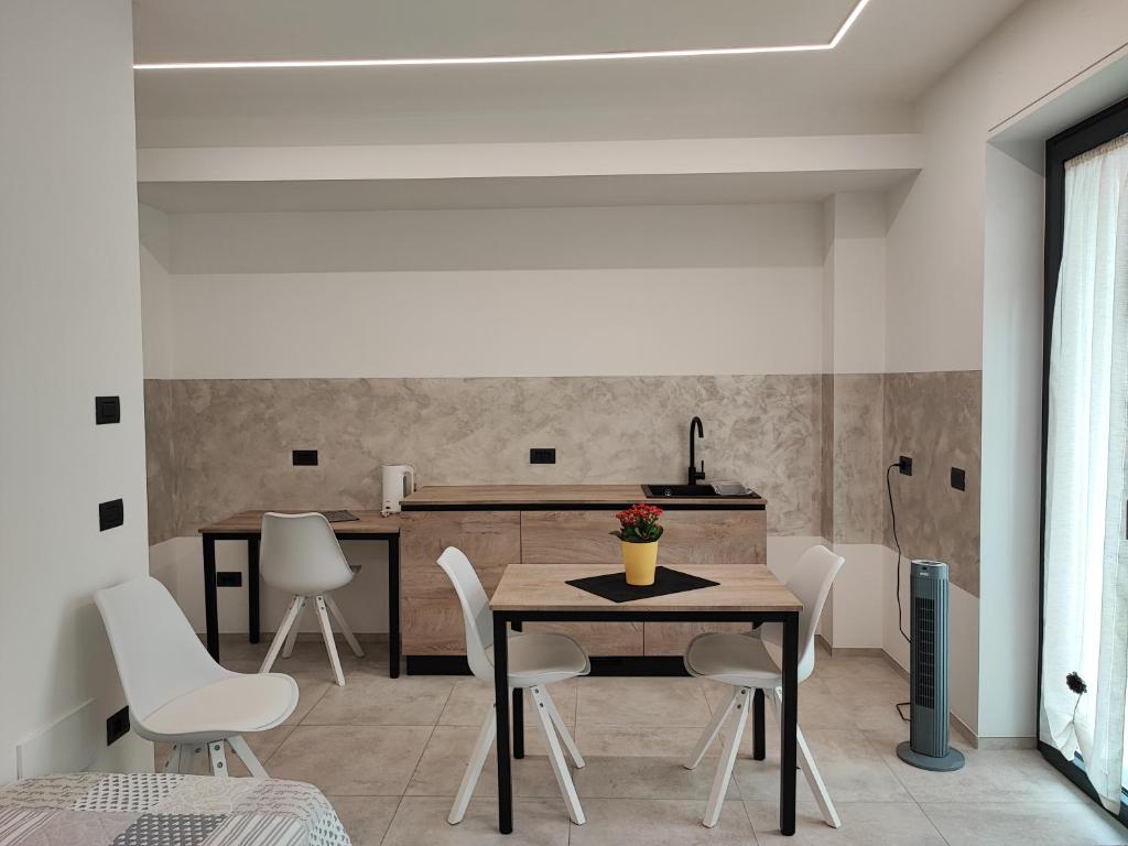 a kitchen and dining room with a table and chairs at Triple C or Quadruple D - MyAostaProject in Aosta