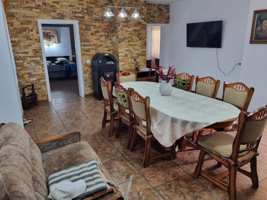 a dining room with a table and chairs and a fireplace at Casa Lucia in Anina