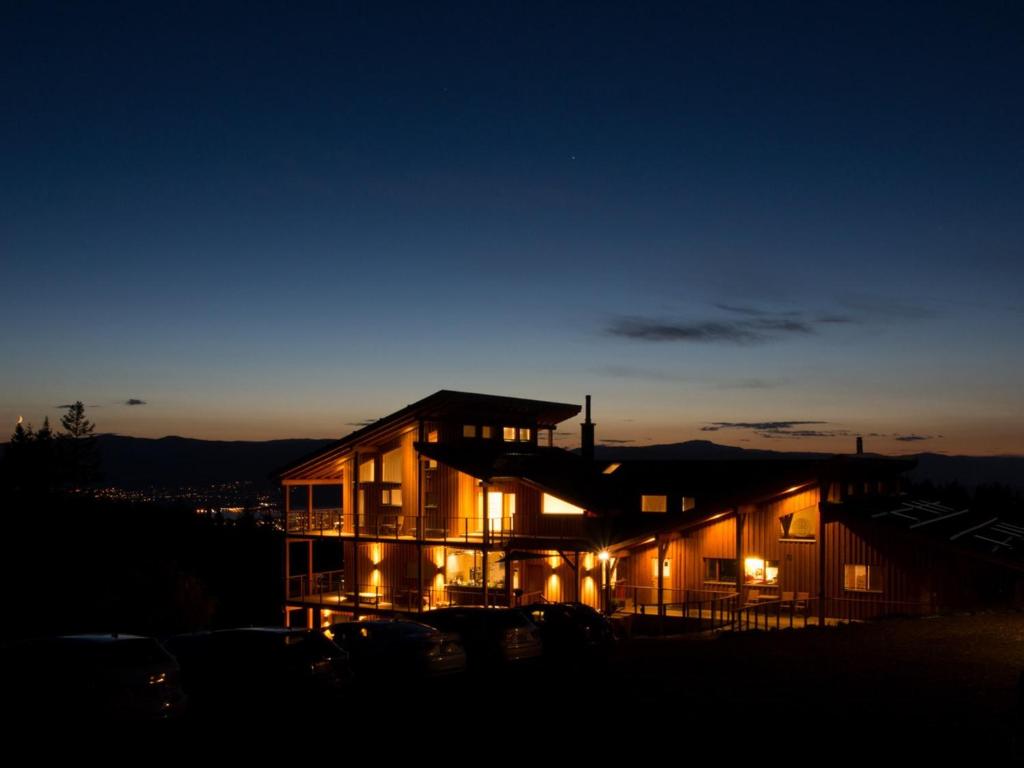 a house lit up at night with lights at Myra Canyon Lodge in Kelowna