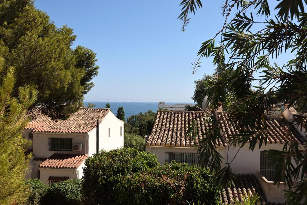 uma vista para duas casas brancas com árvores em Quaint 2 Bedroom Townhouse with Pool close to Sea! em Benalmádena