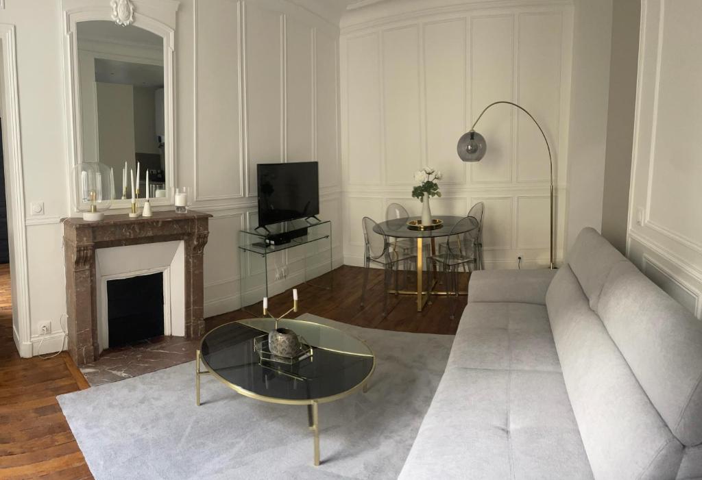 a living room with a couch and a fireplace at Arc de triomphe, Champs Elysées, Foch Avenue Luxury apartment in Paris