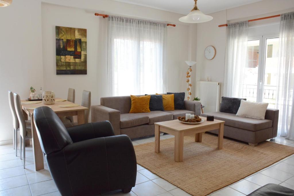 a living room with a couch and a table at M home place in Palio Limani