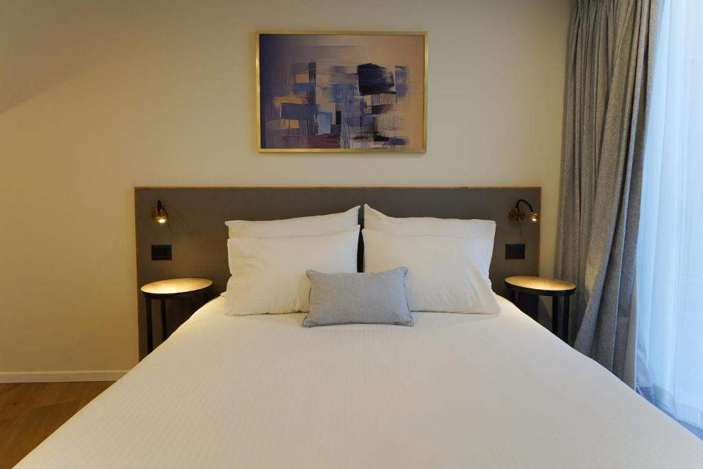Postel nebo postele na pokoji v ubytování Urbanic Hotel
