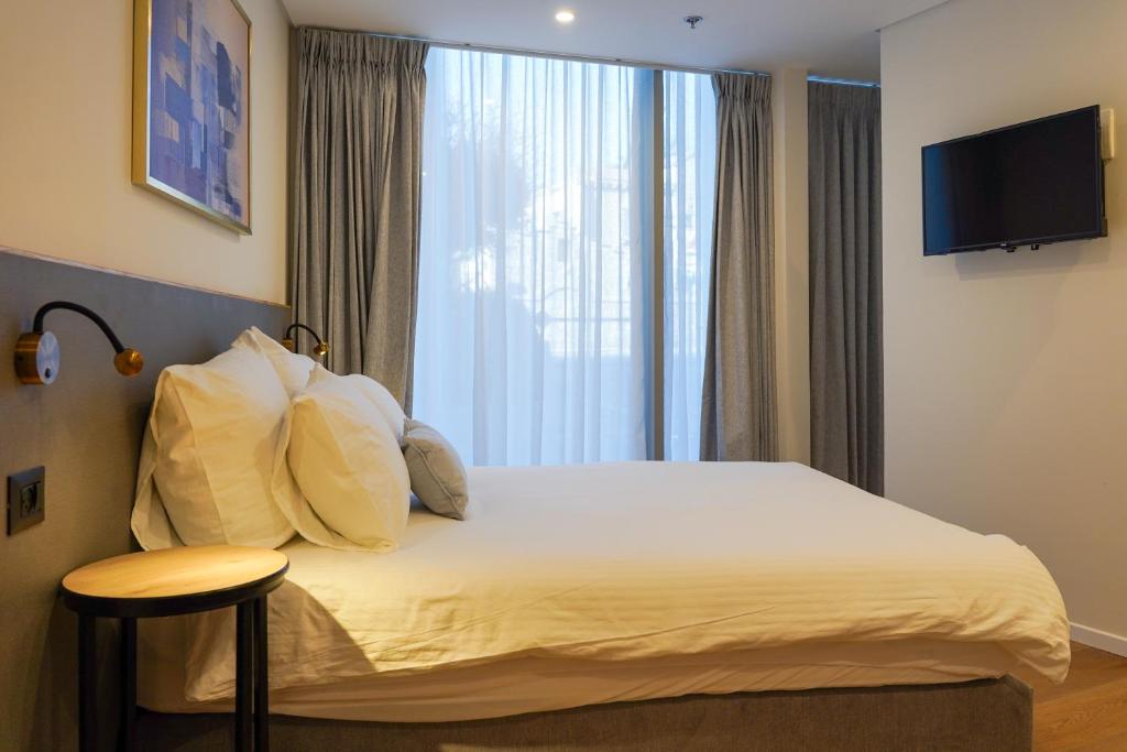 Postel nebo postele na pokoji v ubytování Urbanic Hotel
