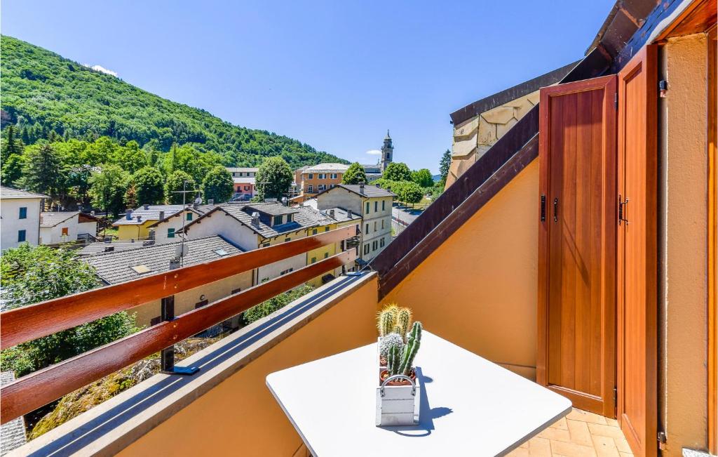 a balcony with a table and a view at Nice Apartment Santo Stefano in Santo Stefano dʼAveto