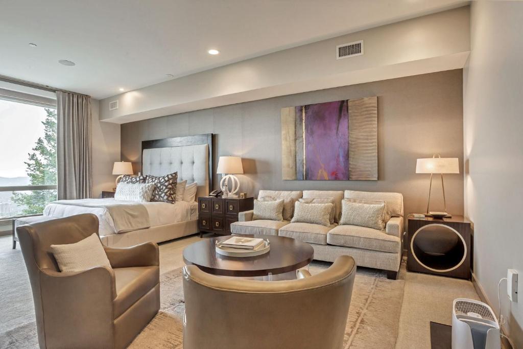 a living room with a bed and a couch at Platinum Room Hotel Room in Park City