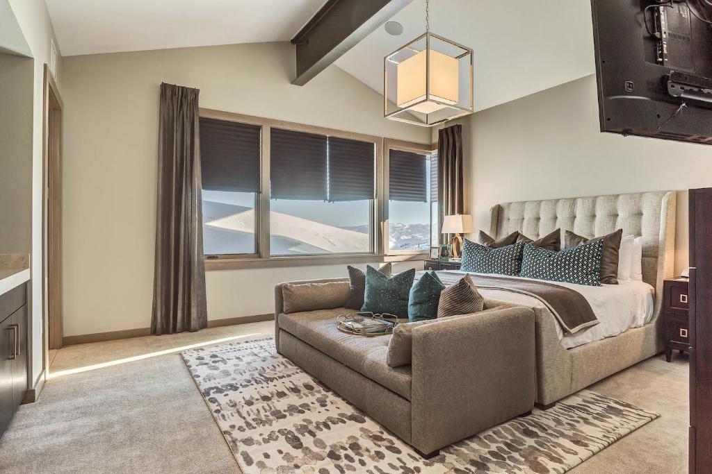 a bedroom with a bed and a couch and a window at Premium Room Hotel Room in Park City