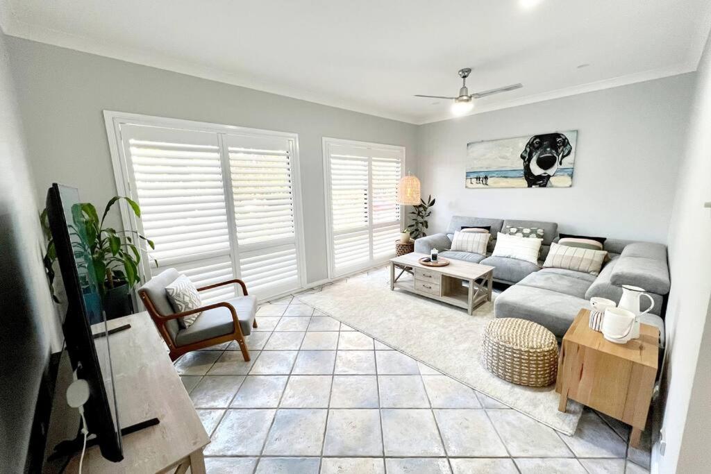 a living room with a couch and a table at Ally’s Umina Oasis, pet-friendly spa coastal oasis in Umina