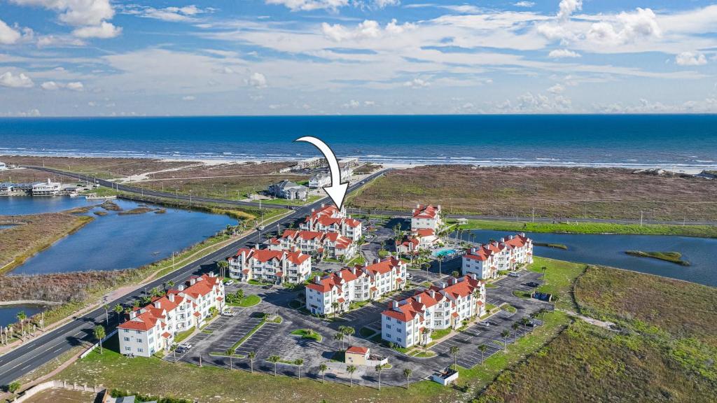 an aerial view of a resort by the ocean at Oceanside Retreat in Corpus Christi