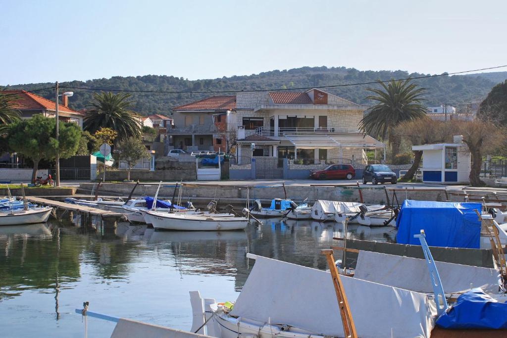 a group of boats docked in a harbor with houses at Apartments by the sea Slatine, Ciovo - 9454 in Slatine