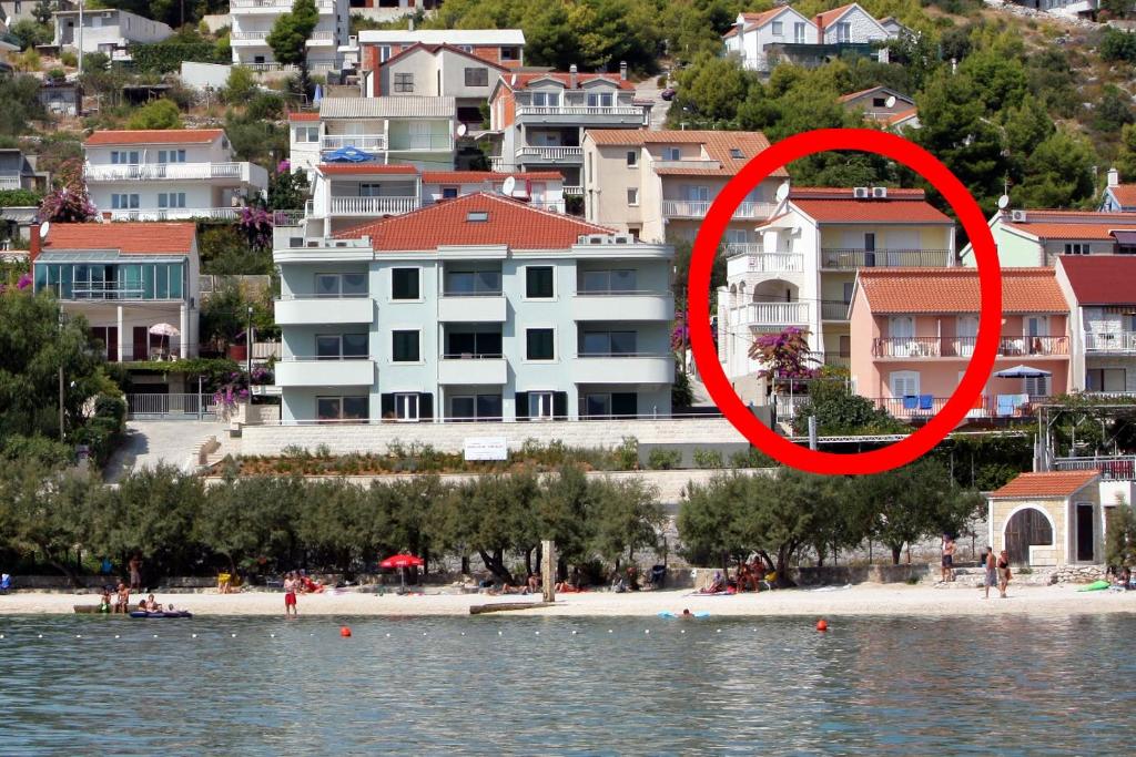 a view of a beach with a red circle at Apartments by the sea Marina, Trogir - 10003 in Marina