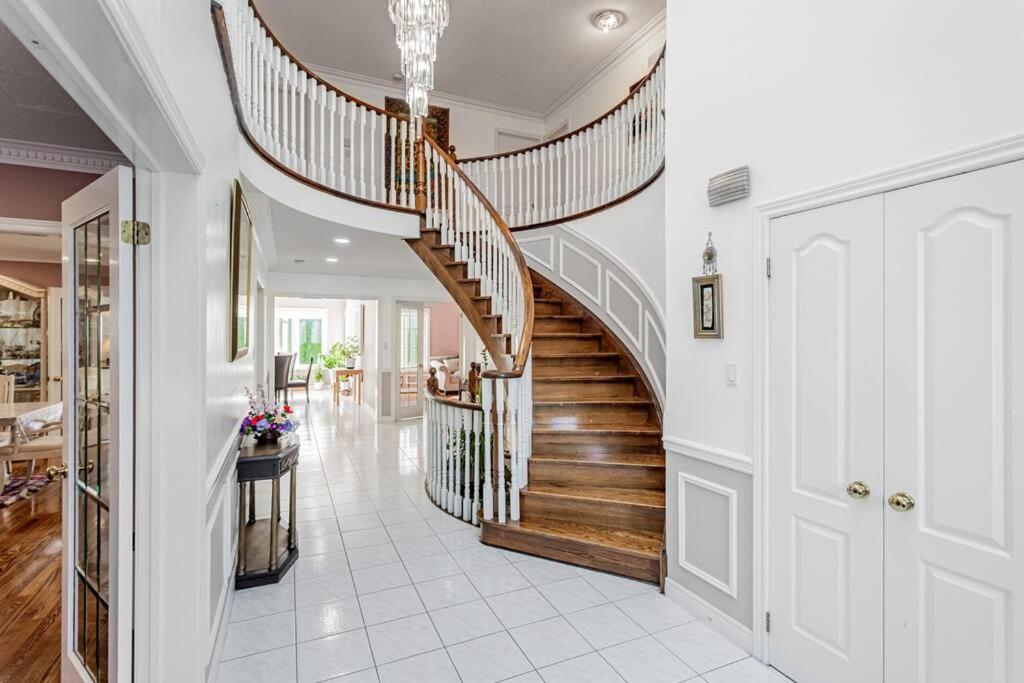 a hallway with a spiral staircase in a home at Luxurious Spacious Dream Home in Richmond Hill