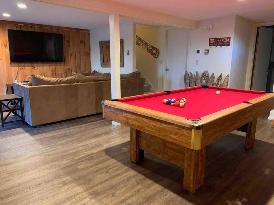 a living room with a pool table and a couch at Dog friendly Chalet in the Woods w/Pool-Mt. Snow in Wilmington