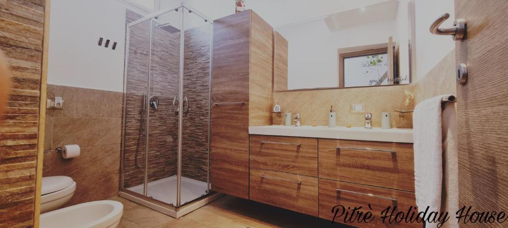 a bathroom with a shower and a toilet and a sink at pitrè holiday house in Palermo