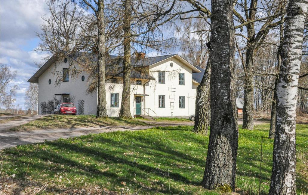 a white house with a red car parked in front of it at App, 1 in Edet