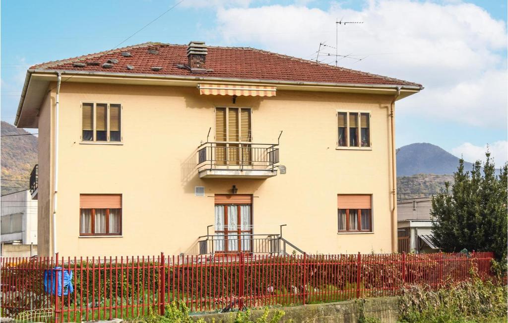 a house with a red fence in front of it at Beautiful Home In Santambrogio Di T, With Wifi in SantʼAmbrogio di Torino