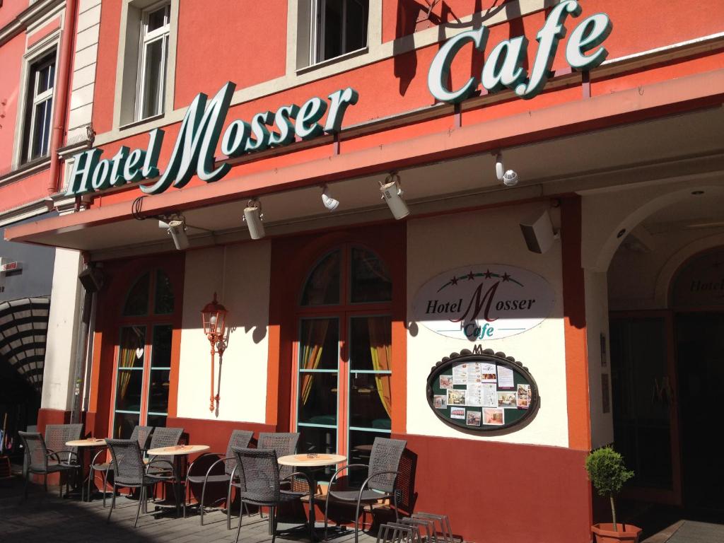 a restaurant with tables and chairs outside of it at Appartement Mosser in Villach