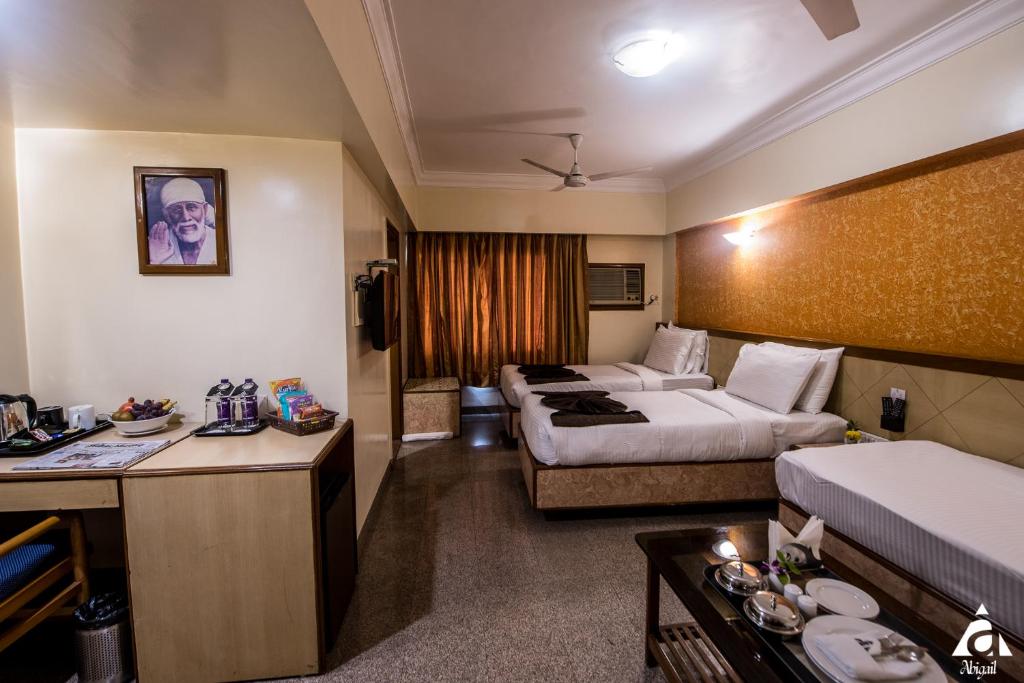 Postel nebo postele na pokoji v ubytování Hotel Abigail Goradia's