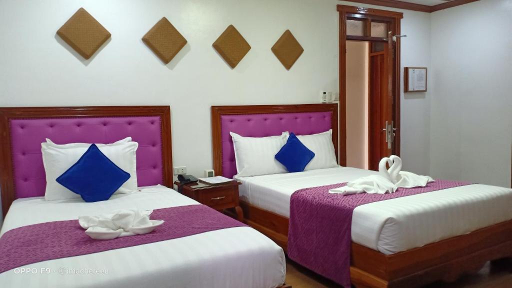 Postel nebo postele na pokoji v ubytování CLN Boutique Hotel