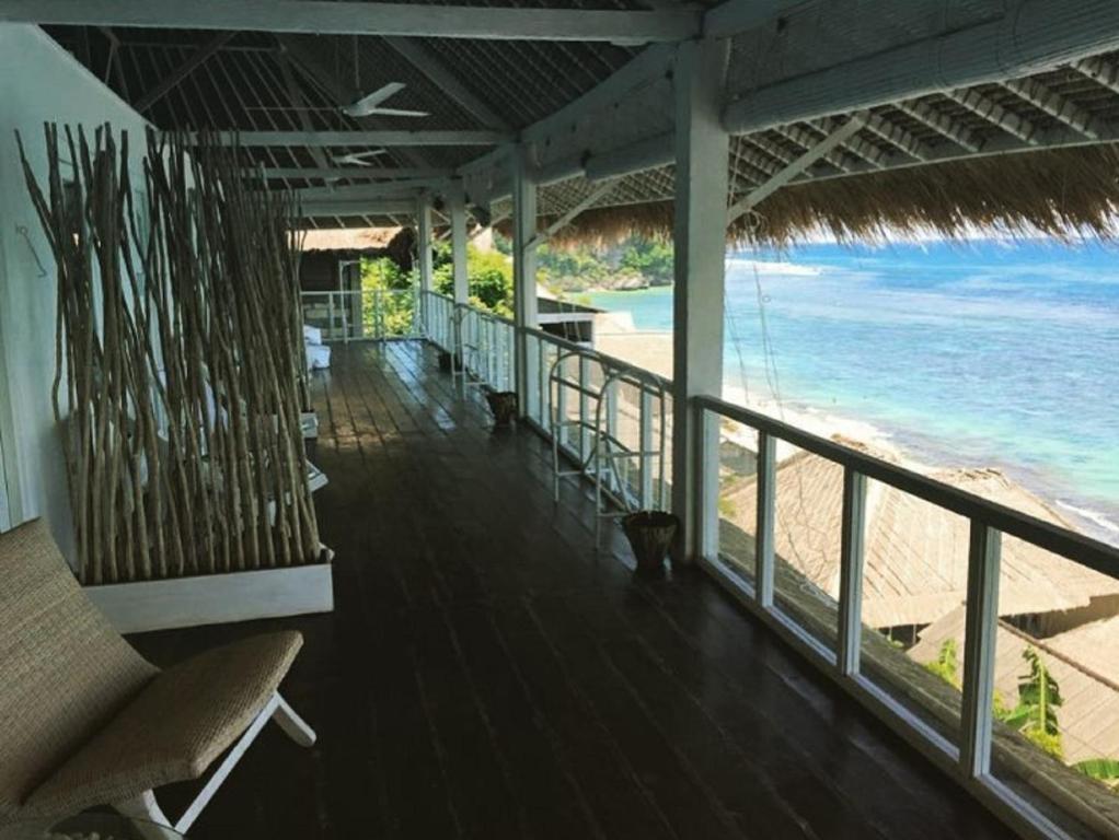 a balcony with a view of the beach and the ocean at Sal Secret Spot in Uluwatu